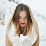 woman holding and looking at ice during daytime