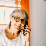woman in white scoop neck shirt wearing black framed eyeglasses