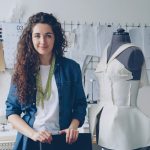 A fashion designer poses in her workshop.