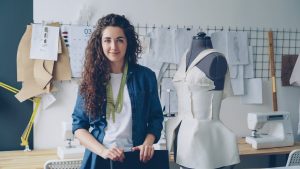 A fashion designer poses in her workshop.